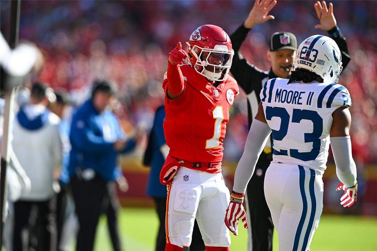 Kansas City Chiefs wide receiver Xavier Worthy (1) talks to Indianapolis Colts cornerback Kenny Moore II (23) on Sunday, Nov. 23, 2025, at GEHA Field at Arrowhead Stadium.