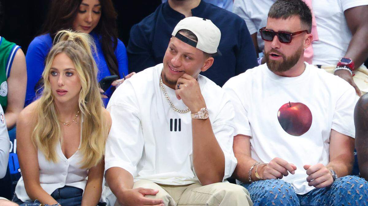 May 26, 2024; Dallas, Texas, USA; Kansas City Chiefs quarterback Patrick Mahomes II sits with his wife Brittany and tight end Travis Kelce during the game between the Dallas Mavericks and Minnesota Timberwolves during game three of the western conference finals for the 2024 NBA playoffs at American Airlines Center. Mandatory Credit: Kevin Jairaj-USA TODAY Sports