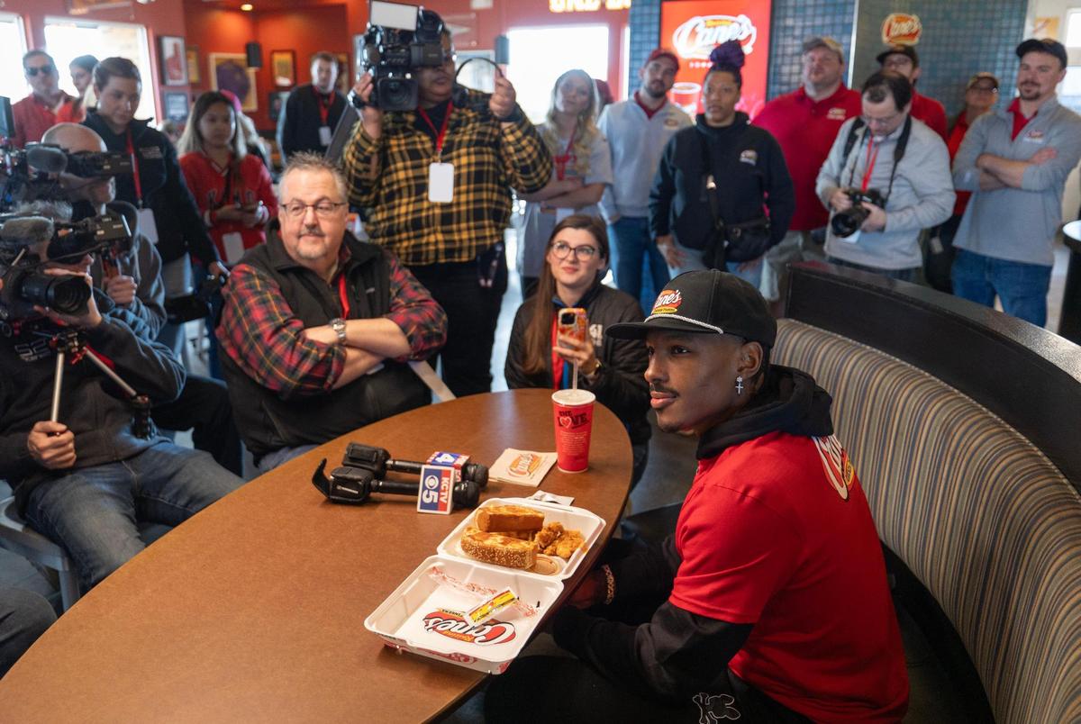 Kansas City Chiefs receiver Mecole Hardman Jr., takes question from reporters while working at a Raising Cains restaurant in Blue Springs on Tuesday. Hardman was joined by teammate L’Jarius Sneed at the event.