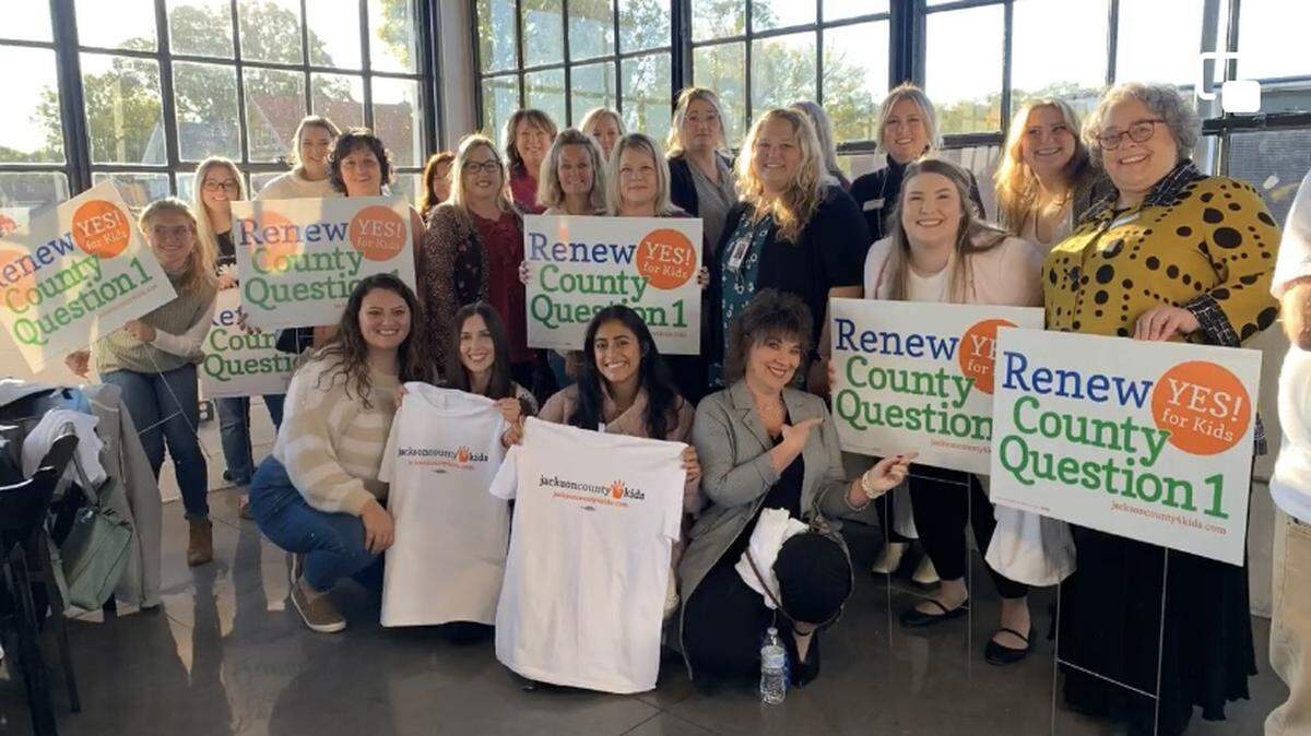 Hope House staff members gather for a rally to stand up for victims’ rights. The focus of the domestic-violence shelter has moved toward transitional and permanent housing.