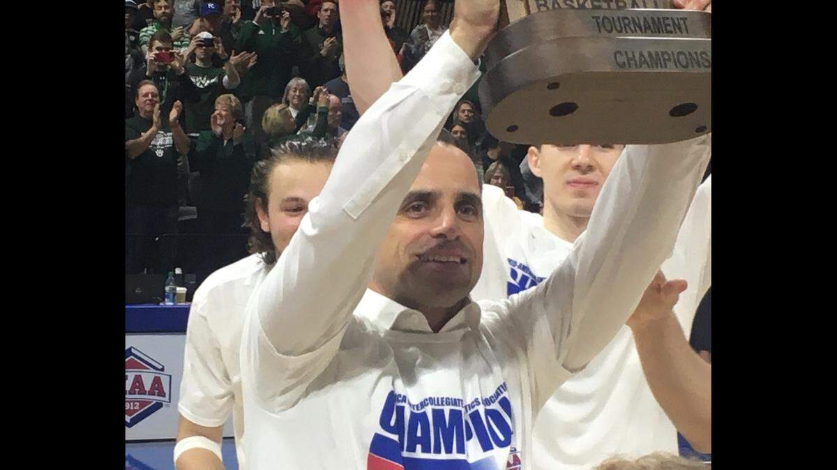 Northwest Missouri State coach Ben McCollum lifts the trophy after his team wins another MIAA men’s championship at Municipal Auditorium on March 5, 2023.