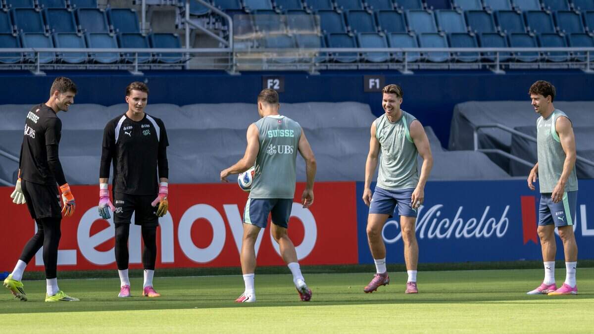 Members of the Switzerland national soccer team warm up by passing a ball in a circle before practice at Sporting Park on Thursday, July 9, 2026, in Kansas City, Kansas.