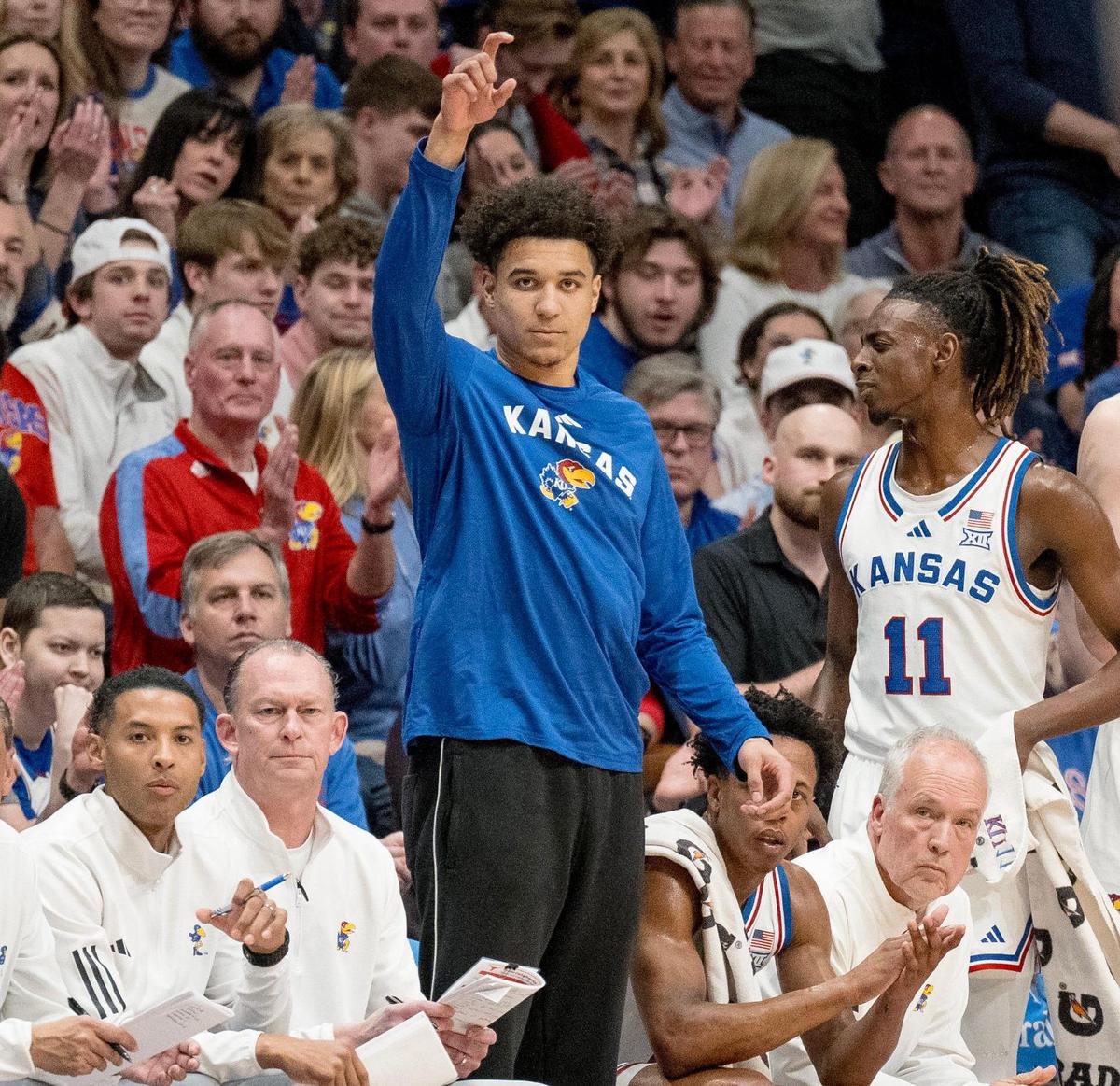 Kansas Jayhawks guard Kevin McCullar Jr. points to a teammate while standing on the sideline during an NCAA basketball game against the Texas Longhorns on Saturday, Feb. 24, 2024, in Lawrence.