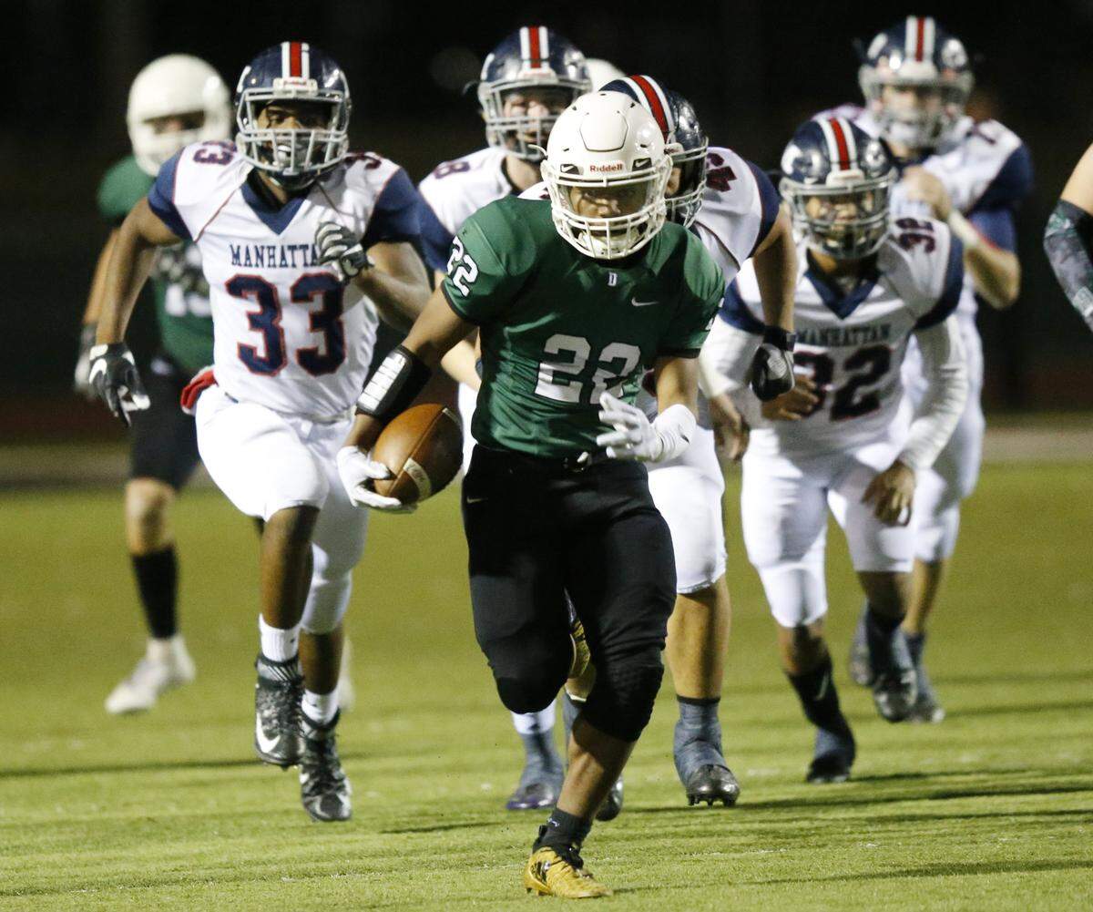 Derby running back Tre Washington ran for the end zone ahead of the Manhattan defense on Friday night at Derby.