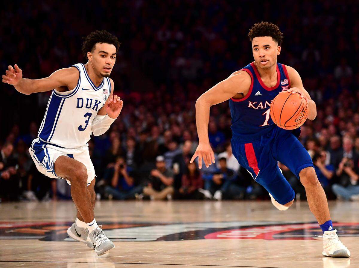 Devon Dotson #1 of the Kansas Jayhawks dribbles the ball down court while being guarded by Tre Jones #3 of the Duke Blue Devils during the second half of their game at Madison Square Garden on November 05, 2019 in New York City.
