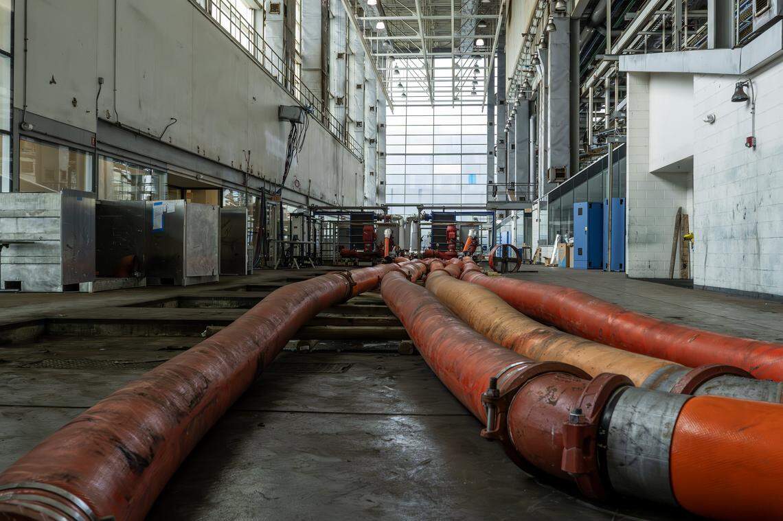 Large chilled water pipes run across the floor inside the former Kansas City Star printing press hall on Wednesday, Sept. 10, 2025, in Kansas City, Mo. The system is part of renovations to cool data areas in Patmos' new technology campus.