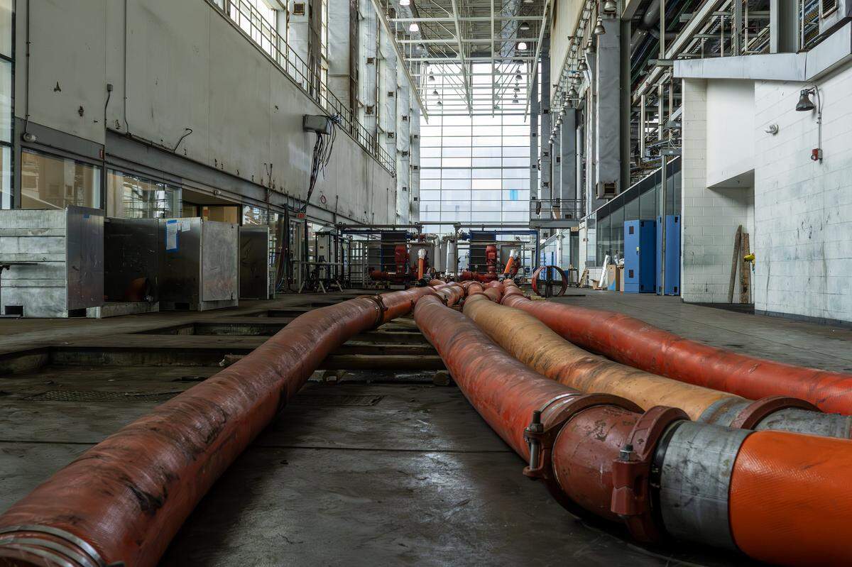 Large chilled water pipes run across the floor inside the former Kansas City Star printing press hall on Wednesday, Sept. 10, 2025, in Kansas City, Mo. The system is part of renovations to cool data areas in Patmos' new technology campus.