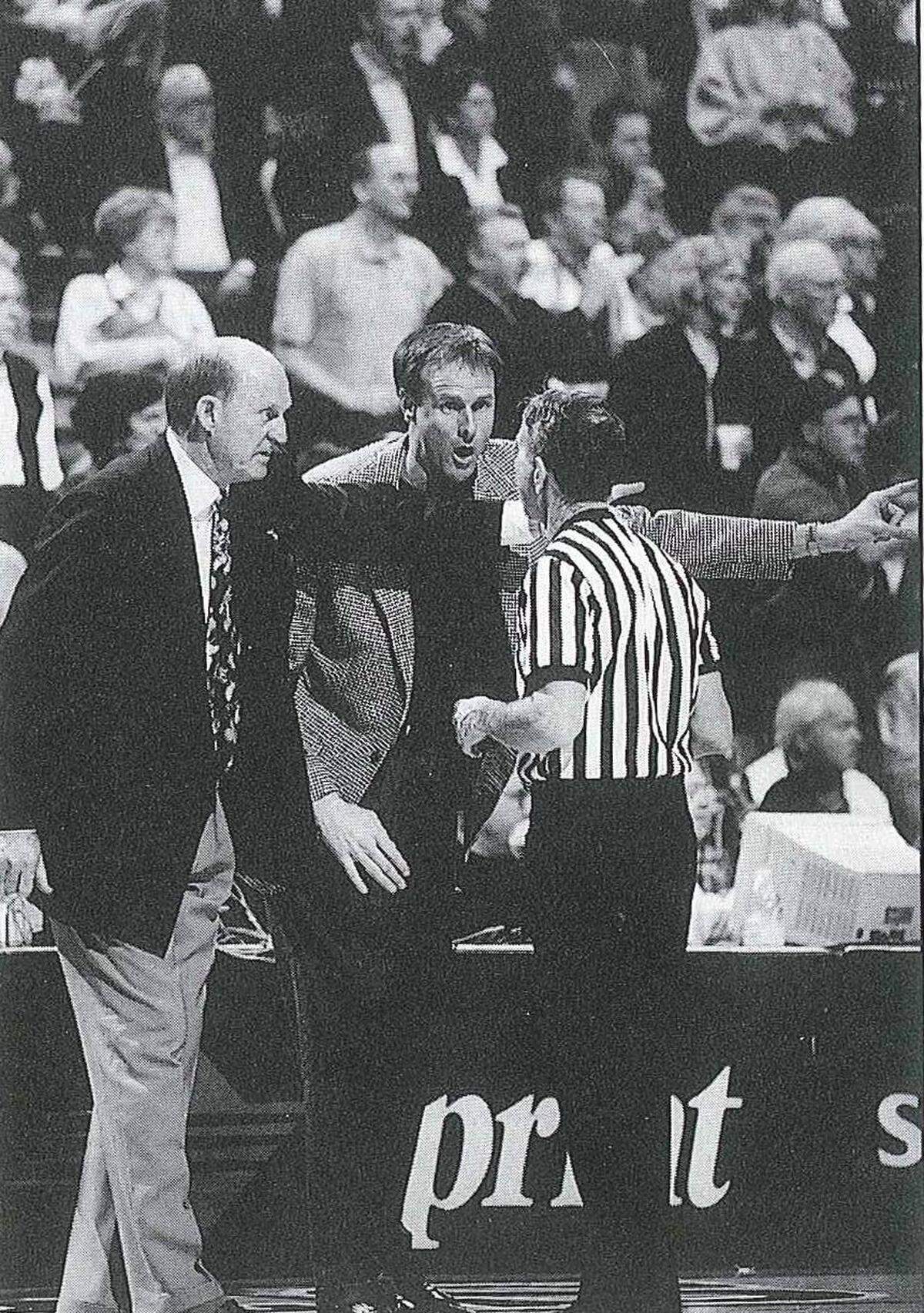 Missouri Tigers head coaching legend Norm Stewart, at left, gives an official an earful during a Mizzou college basketball game.