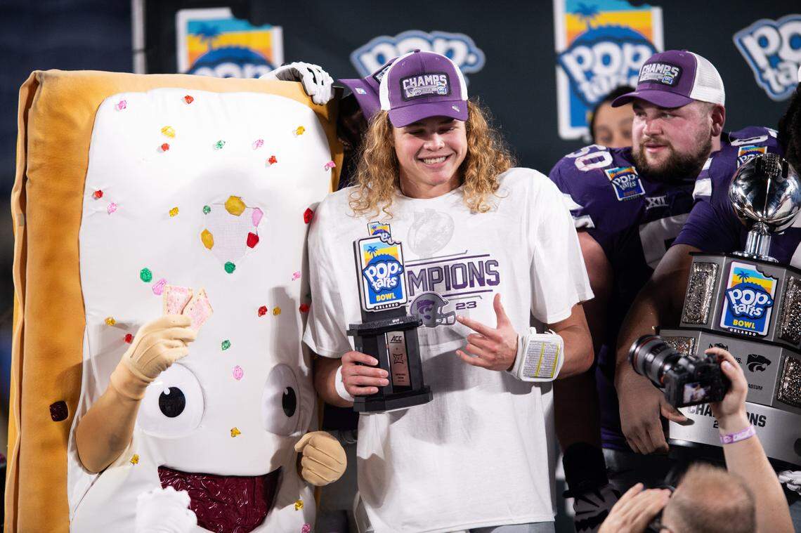 Kansas State quarterback Avery Johnson (2) celebrates his MVP honors with the Pop-Tarts mascot at Camping World Stadium on Dec. 28, 2023.