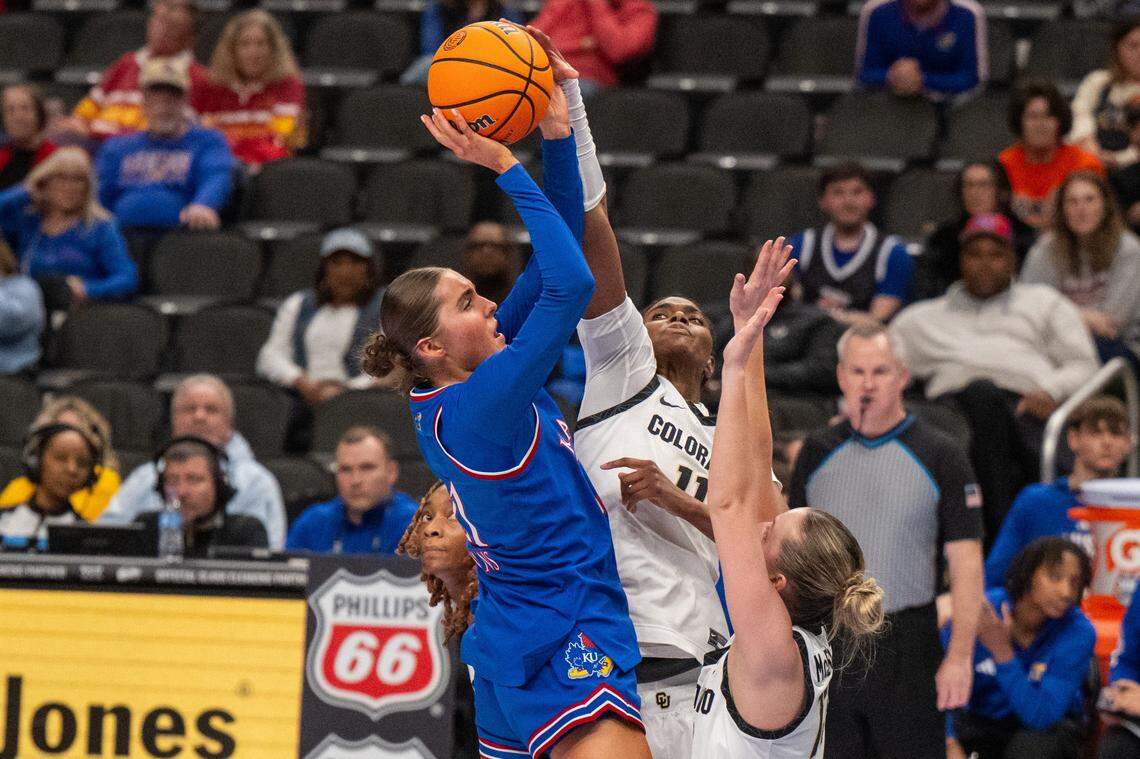 Kansas Jayhawks guard Elle Evans (21) has her shot blocked by Colorado Buffaloes forward Logyn Greer (11) during the second half of KU’s second-round game at the Big 12 Women's Basketball Tournament on Thursday, March 5, 2026, at T-Mobile Center in Kansas City.