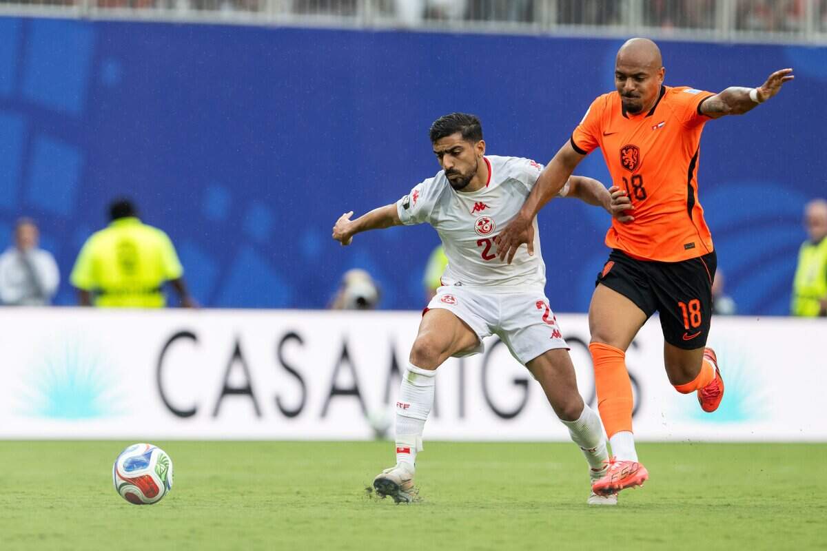 Tunisia defender Mohamed Amine Ben Hamida (21) fights for the ball against Netherlands midfielder Donyell Malen (18) in a FIFA World Cup group-stage soccer match at Kansas City (Arrowhead) Stadium in Kansas City on Thursday, June 25, 2026.