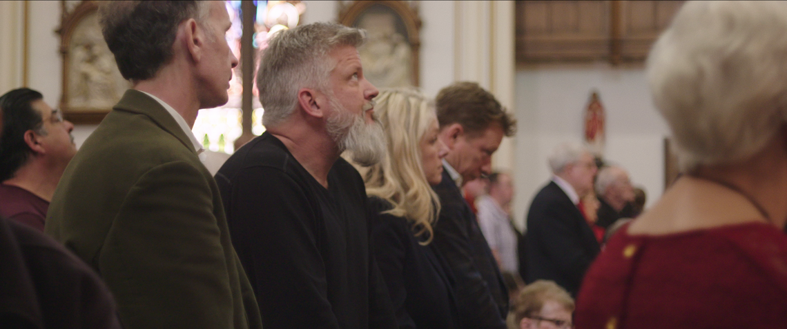 In “Procession,” Michael Sandridge (from left), Dan Laurine, Eileen Gavagan and her brother Ed Gavagan attend Mass in Cheyenne, Wyoming.