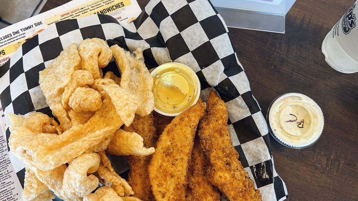 Strip’s Chicken Strips & Dive Bar serves chicken strips with a choice of two sauces and a side.