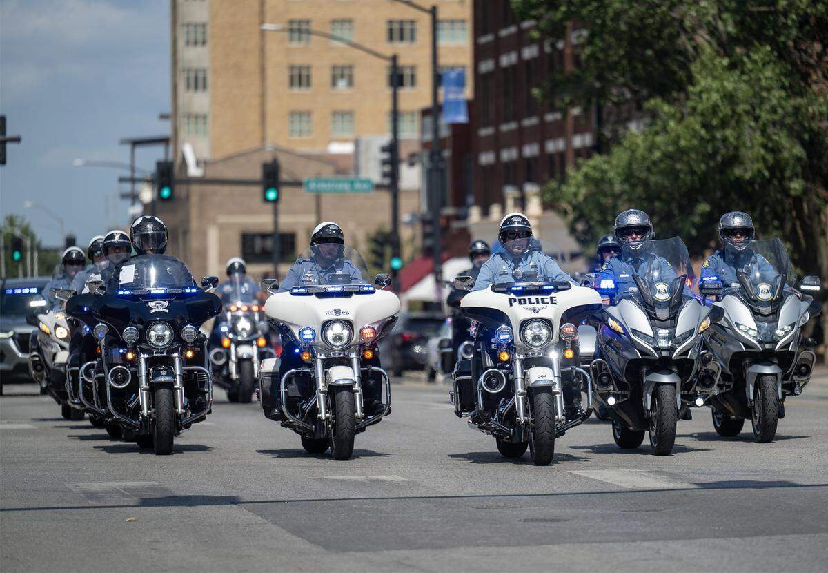 Motorcycle officers lead the procession for Kansas City, Kansas Police Officer Hunter Simoncic as it traveled through downtown Kansas City, Kansas, on Wednesday, Sept. 3, 2025.