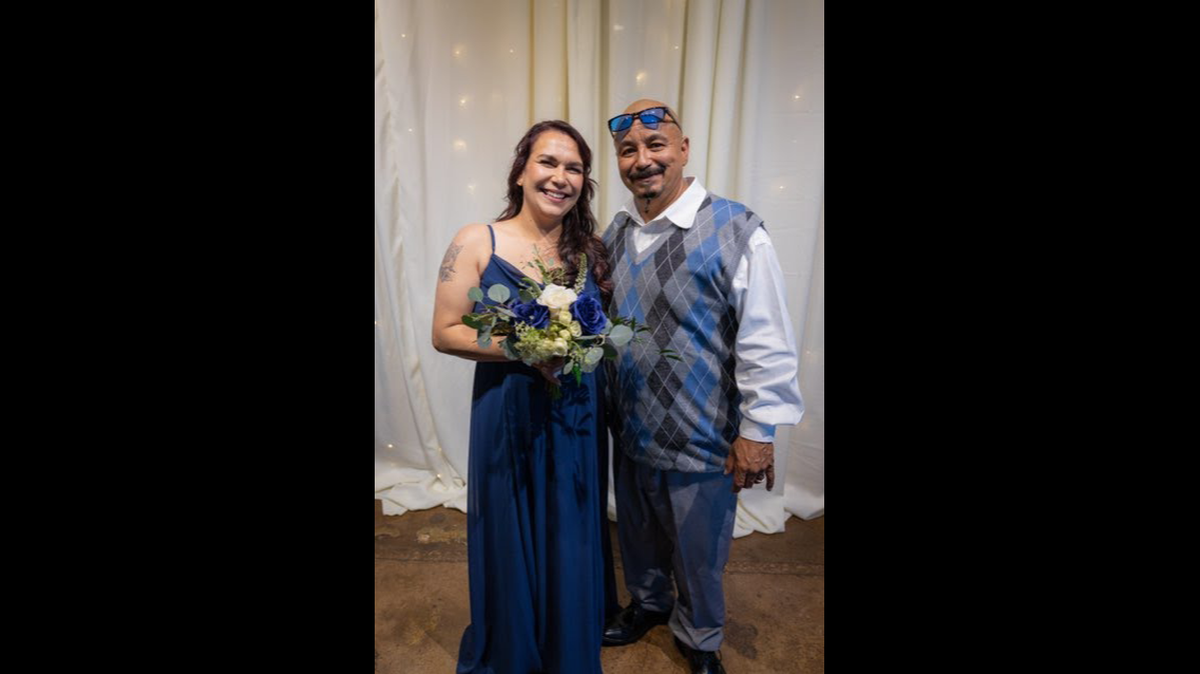 George Abasta poses for a picture with his wife Celeste Lamar at her sister Rachel’s wedding in 2022. Abasta, 50, an Olathe father of six, was allegedly hit and killed by a semi-truck driver on Oct. 9, 2023, after trying to cross I-435 near Metcalf Avenue after he was involved in a car wreck. The truck driver, Overland Park police said, did not stop.