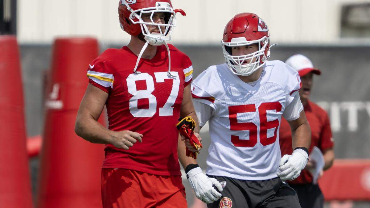 Kansas City Chiefs tight end Travis Kelce (87) and  defensive end George Karlaftis (56) warm up during practice at team's training facility on Wednesday, August 20, 2025.  in Kansas City 