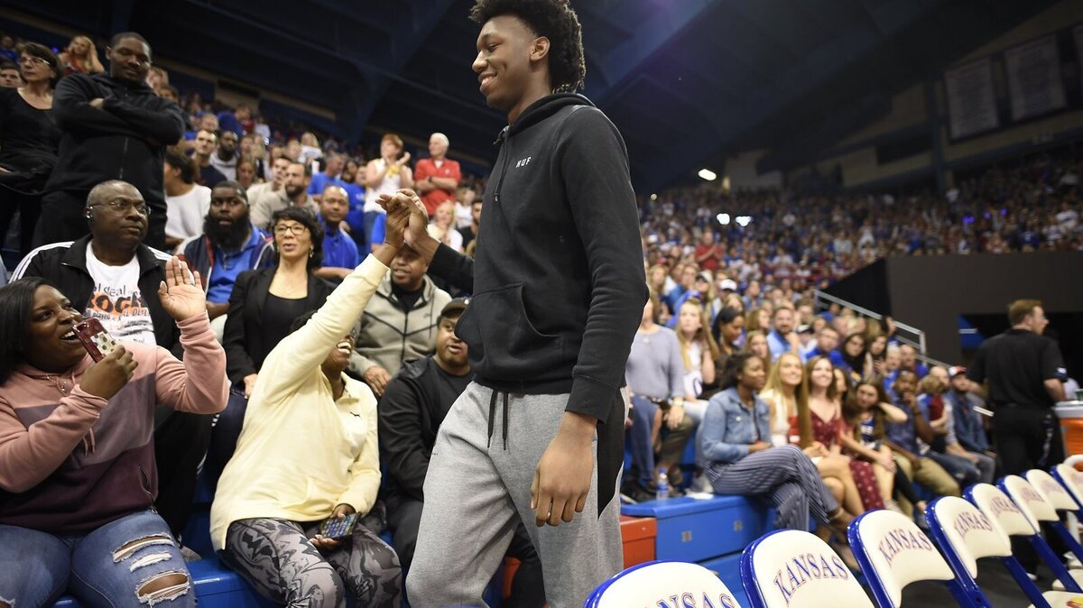 KU recruit James Wiseman, a 7-foot 210-pound big man, high fives with Jayhawks fans during Friday’s Late Night in the Phog at Allen Fieldhouse.