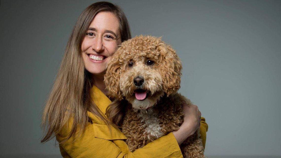 Katie Harris of Lenexa lives with a debilitating disease. Her goldendoodle service dog, Moxie, has changed her life.