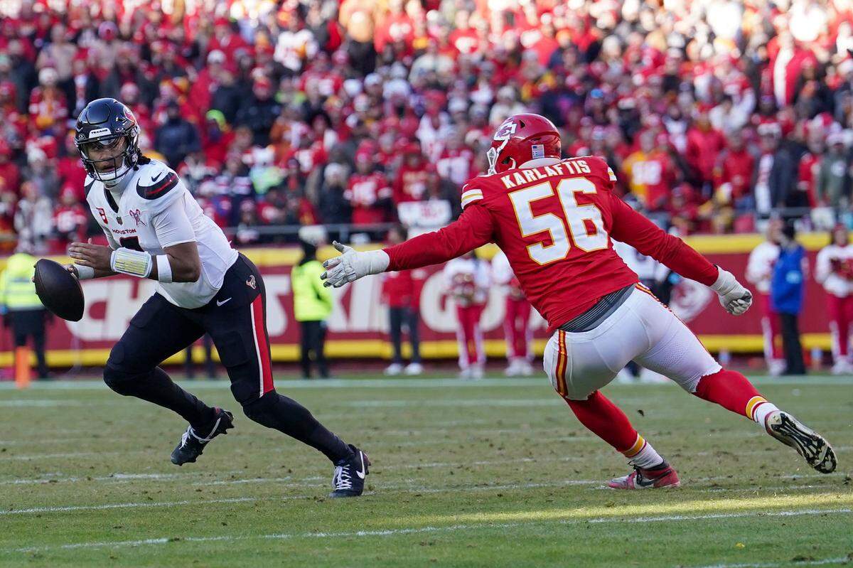 Houston Texans quarterback C.J. Stroud (7) scrambles in the backfield as Kansas City Chiefs defensive end George Karlaftis (56) closes in during the second half at GEHA Field at Arrowhead Stadium on Dec. 21, 2024.