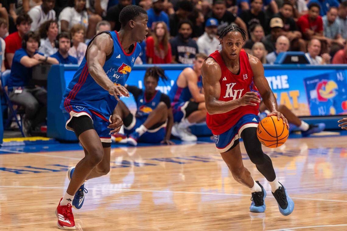Kansas Jayhawks guard Elmarko Jackson dribbles the ball past guard Melvin Council Jr. during the men's scrimmage at Late Night in the Phog, on Friday, October 17, 2025, in Lawrence.
