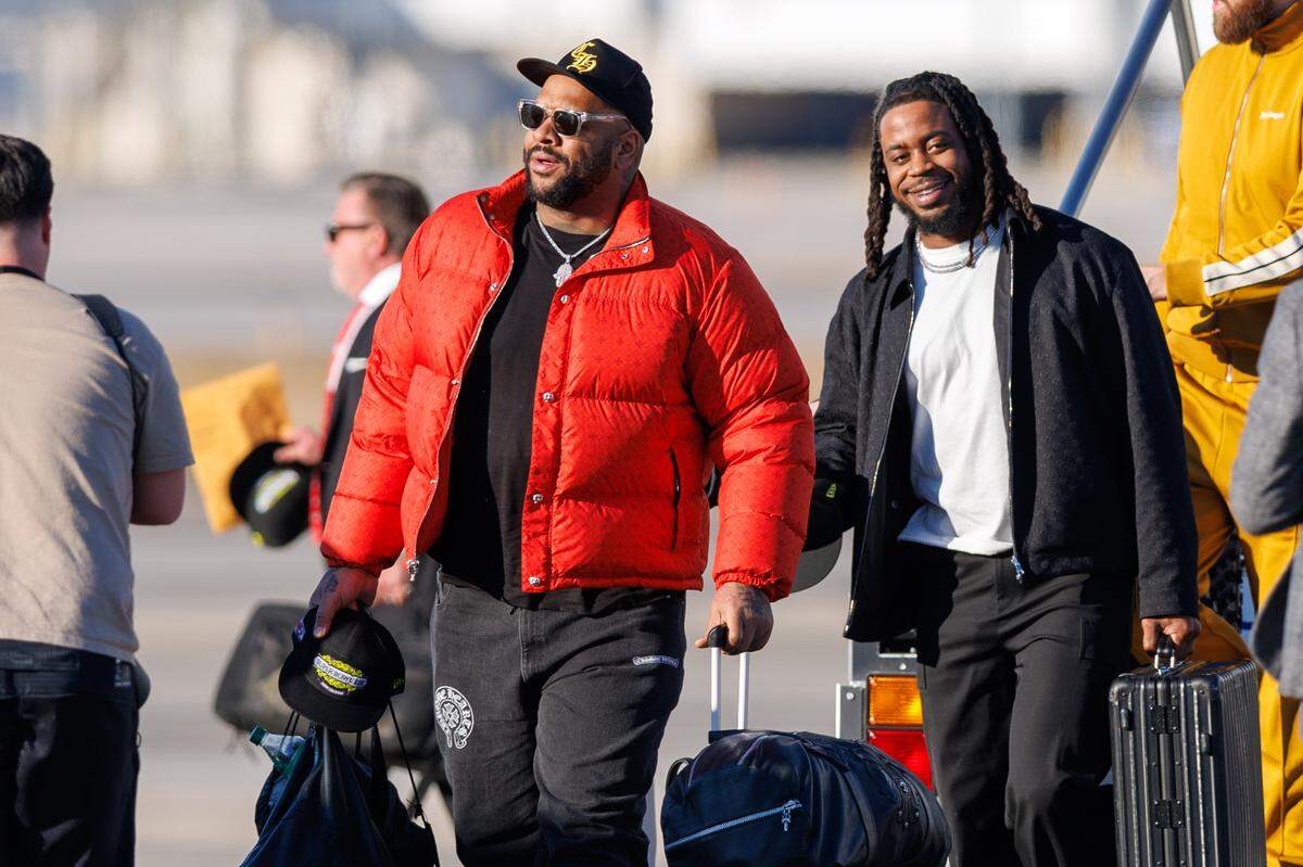 Members of the Kansas City Chiefs exit the plane after arriving at Louis Armstrong New Orleans International Airport on Feb. 2, 2025.