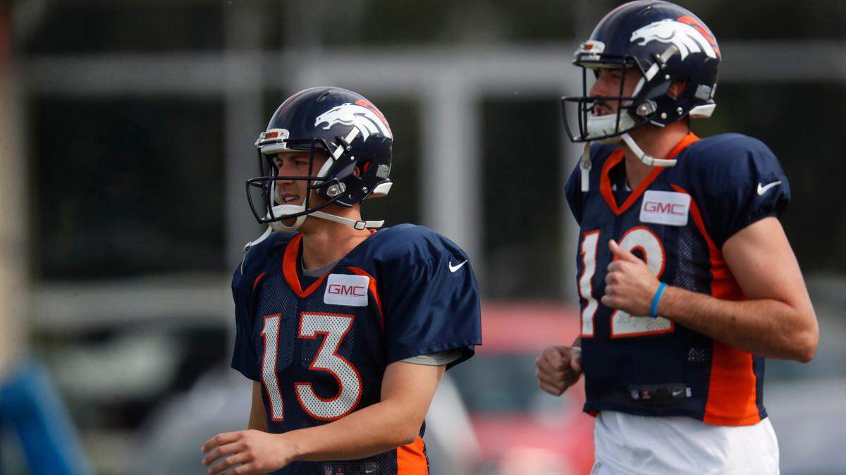Denver Broncos quarterbacks Trevor Siemian, left, and Paxton Lynch takes part in drills at an NFL football training camp Sunday, July 30, 2017, in Englewood, Colo. (AP Photo/David Zalubowski)