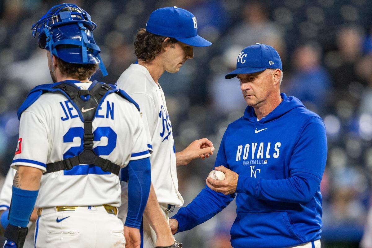 Kansas City Royals relief pitcher Daniel Lynch IV passes the ball to manager Matt Quatraro after being pulled from a game against the Boston Red Sox on Wednesday, May 20, 2026, at Kauffman Stadium.