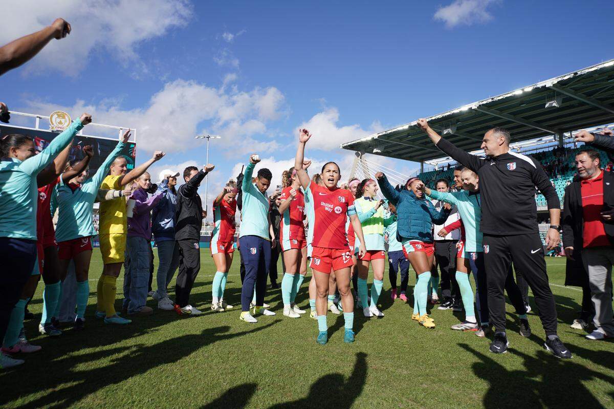 With coach Vlatko Andonovski at far right with raised fish, Kansas City Current midfielder Lo’eau LaBonta, center, addresses the team on the field after a Saturday, Nov. 9. 2024 NWSL playoff victory over the North Carolina Courage at CPKC Stadium.