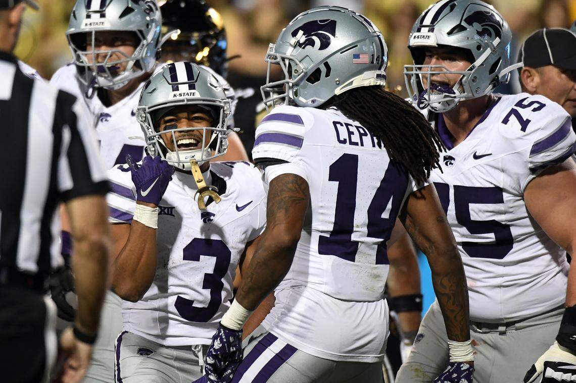 Kansas State Wildcats running back Dylan Edwards celebrates with teammates after a touchdown during Saturday night’s Big 12 football game against the Colorado Buffaloes at Folsom Field in Boulder, Colo.