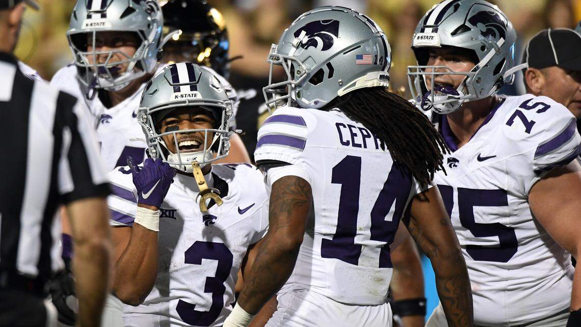 Kansas State Wildcats running back Dylan Edwards celebrates with teammates after a touchdown during Saturday night’s Big 12 football game against the Colorado Buffaloes at Folsom Field in Boulder, Colo.