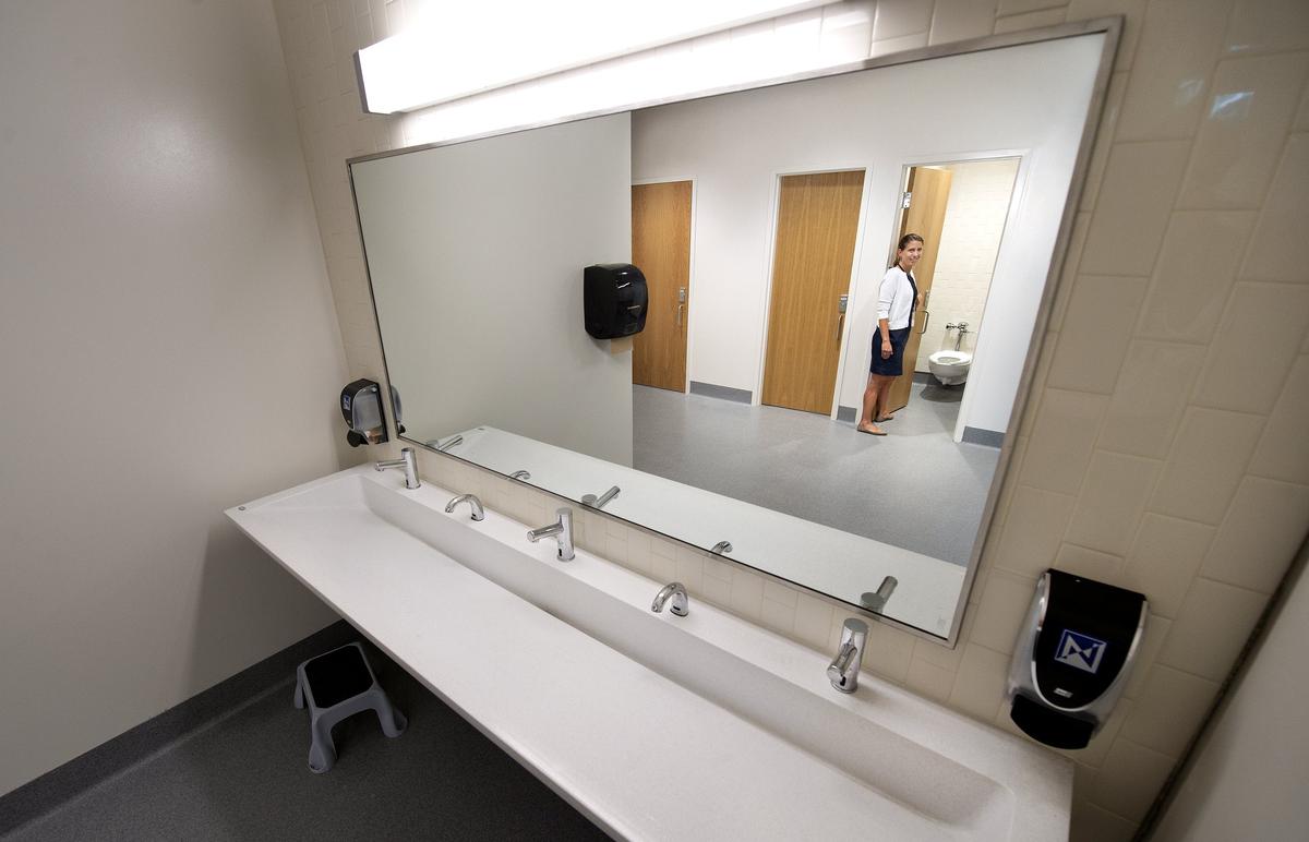 Kate Place, principal of the new Rising Hill Elementary School in the North Kansas City district, gave a tour of the new gender-neutral restrooms.