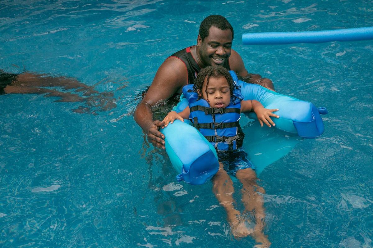 Chuck Hubbard and his son, Mykel, swim in Deb Frey’s Prairie Village pool.