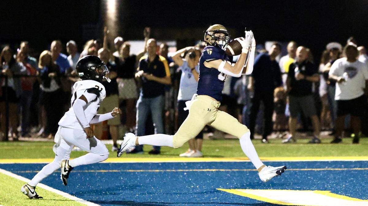 St. Thomas Aquinas High School junior Arthur Witherspoon hauls in one of his two touchdown receptions during a 42-21 football win over Blue Valley on Friday, Sept. 19, 2025.