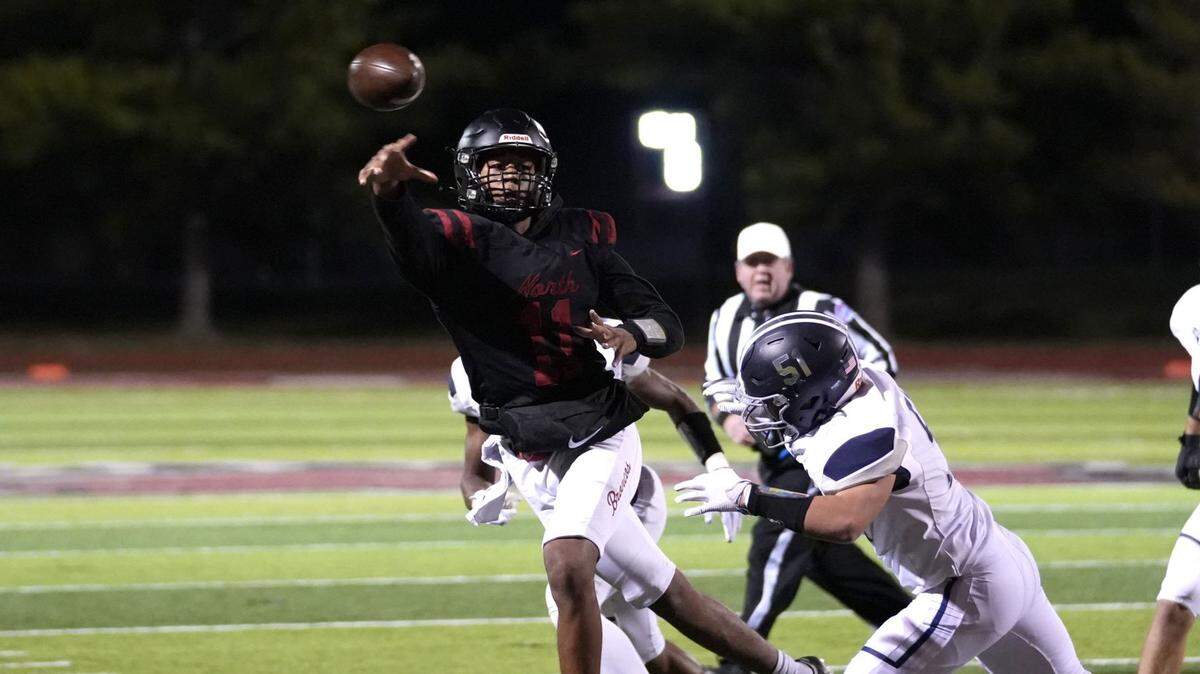 Elijah Leonard throws on the run in Lee’s Summit North’s win on Friday night.