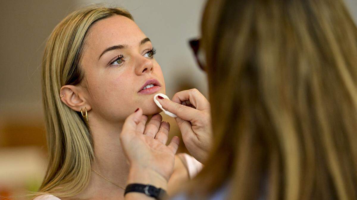 A woman putting on skincare.