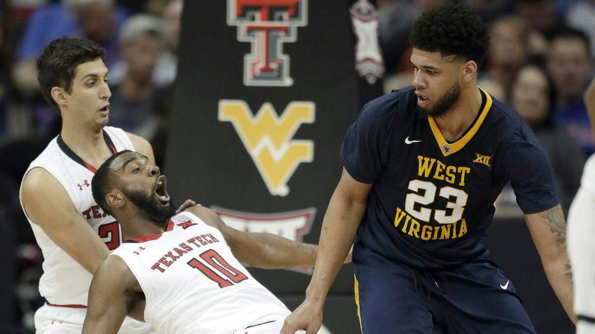 West Virginia forward Esa Ahmad charged into Texas Tech guard Niem Stevenson in the first half of Friday night's Big 12 Tournament semifinal game at the Sprint Center.