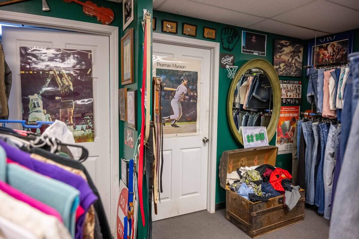 Changing rooms with sports posters on the door inside Gnarly Hussle, a vintage clothing store in Raytown.