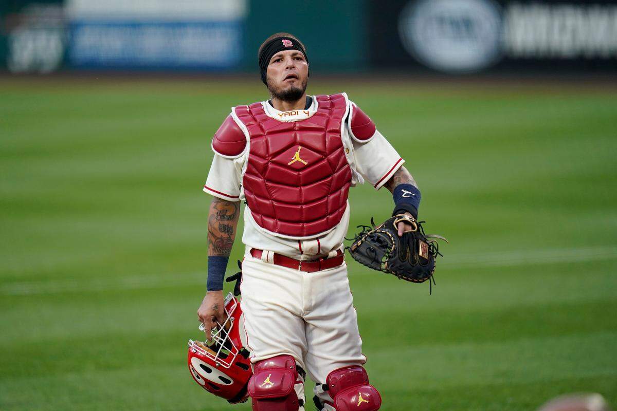 St. Louis Cardinals catcher Yadier Molina heads to the dugout after warming up before the start of a baseball game against the Cincinnati Reds aturday, Aug. 22, 2020, in St. Louis. (AP Photo/Jeff Roberson)
