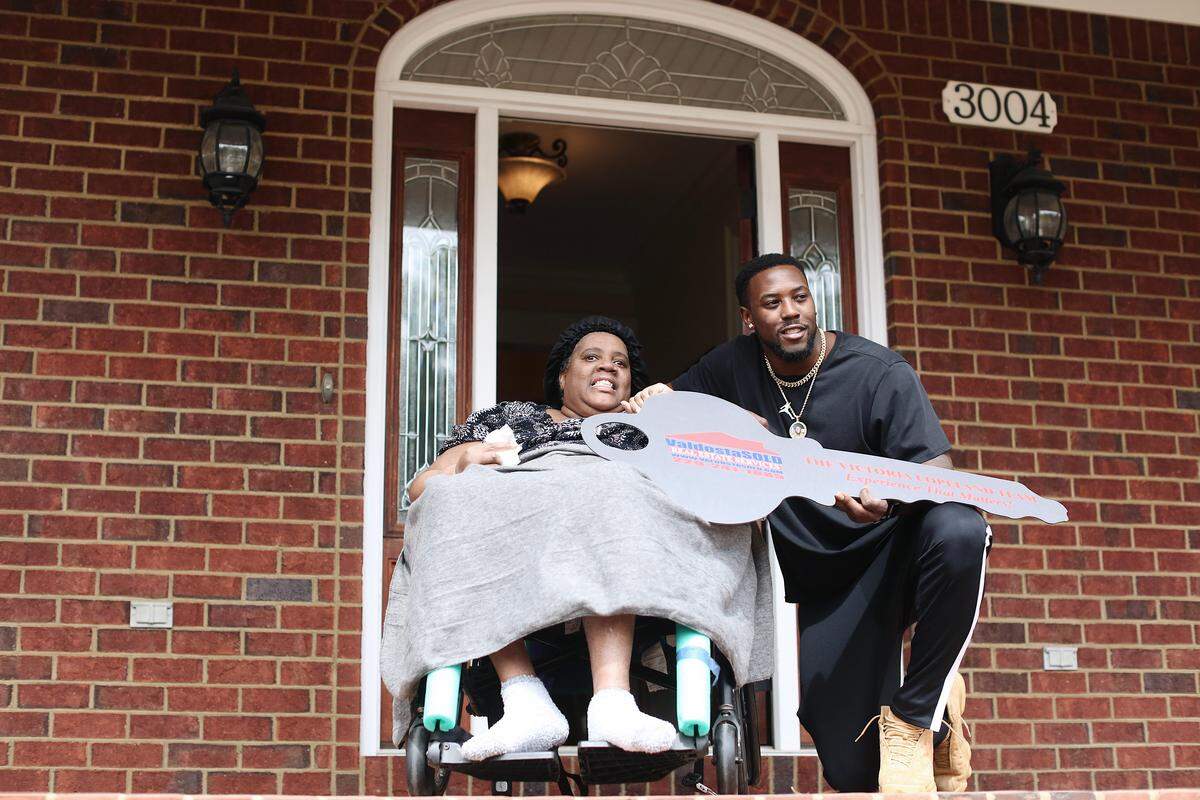 Charles Harris with his mother, Deborah Clark at the new home.