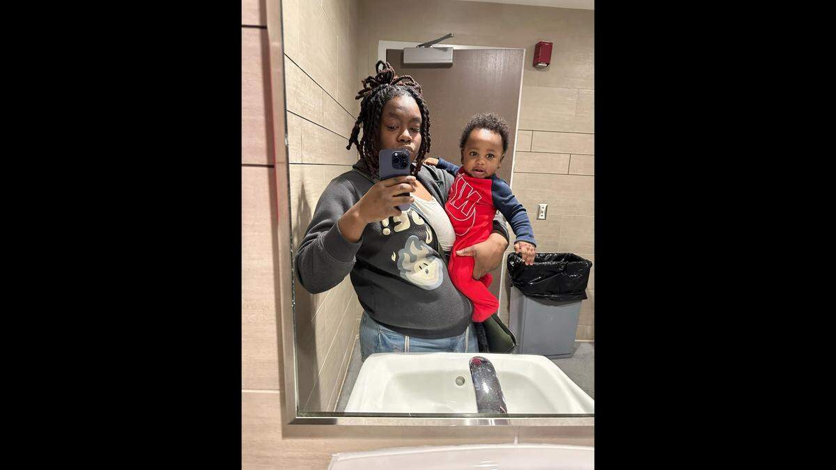 Armoni Carr takes a picture with her baby son, Giovanni. His first birthday would have been Saturday. He died in June.