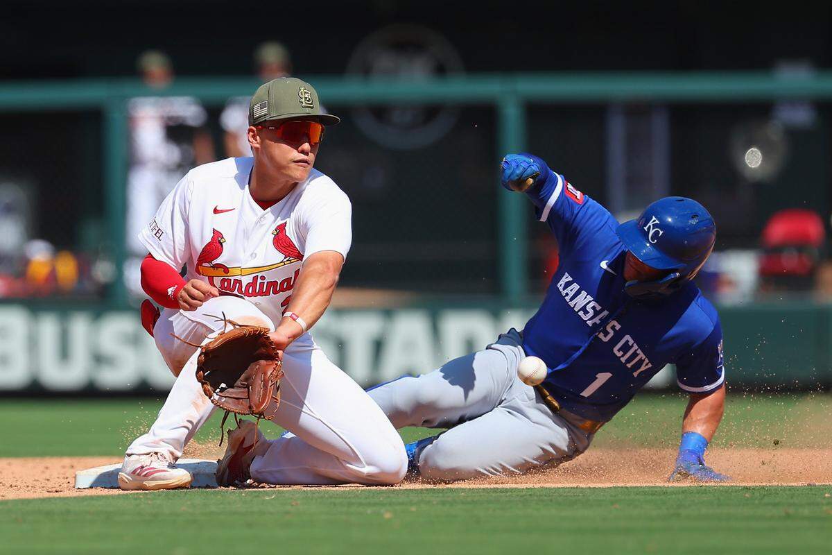 Kansas City Royals left fielder Isaac Collins, right, steals second base in the ninth inning, beating the throw and tag attempt by Cardinals second baseman JJ Wetherholt during KC’s 2-0 win at Busch Stadium in St. Louis on Sunday, May 17, 2026.