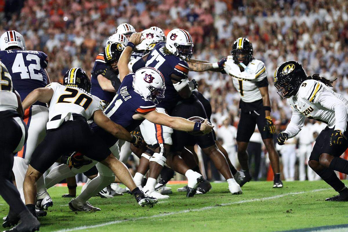 Jackson Arnold #11 of the Auburn Tigers scores a touchdown during the first half against the Missouri Tigers at Jordan-Hare Stadium on October 18, 2025 in Auburn, Alabama.