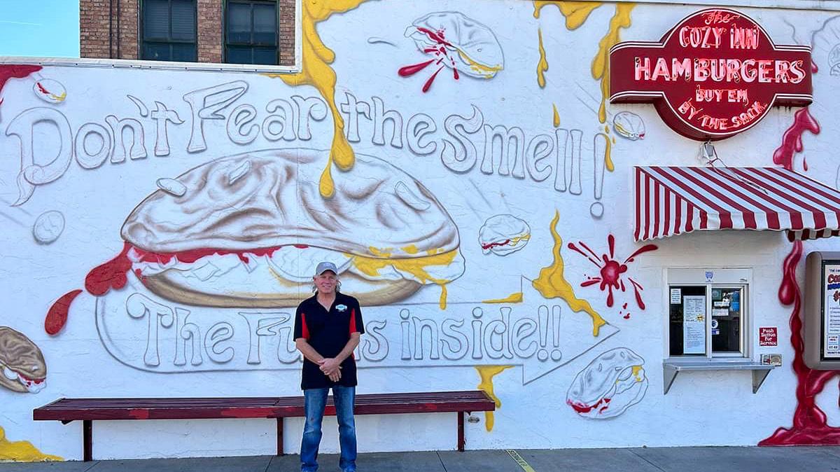 Steve Howard stands next to his business, The Cozy Inn, located at 108 N. 7th St. in Salina, Kansas. Howard filed a lawsuit against the city of Salina last year for free speech violations when he was ordered to stop painting a mural on his building.