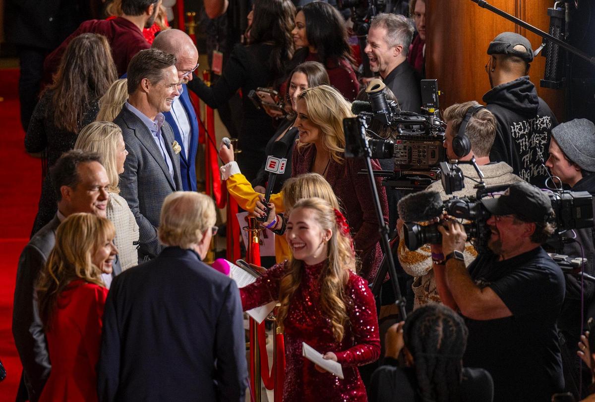 Mark Donovan, president of the Kansas City Chiefs, and coach Andy Reid are interviewed on the red carpet at the Premiere screening of Hallmark’s “Holiday Touchdown: A Chiefs Love Story,” on Saturday.