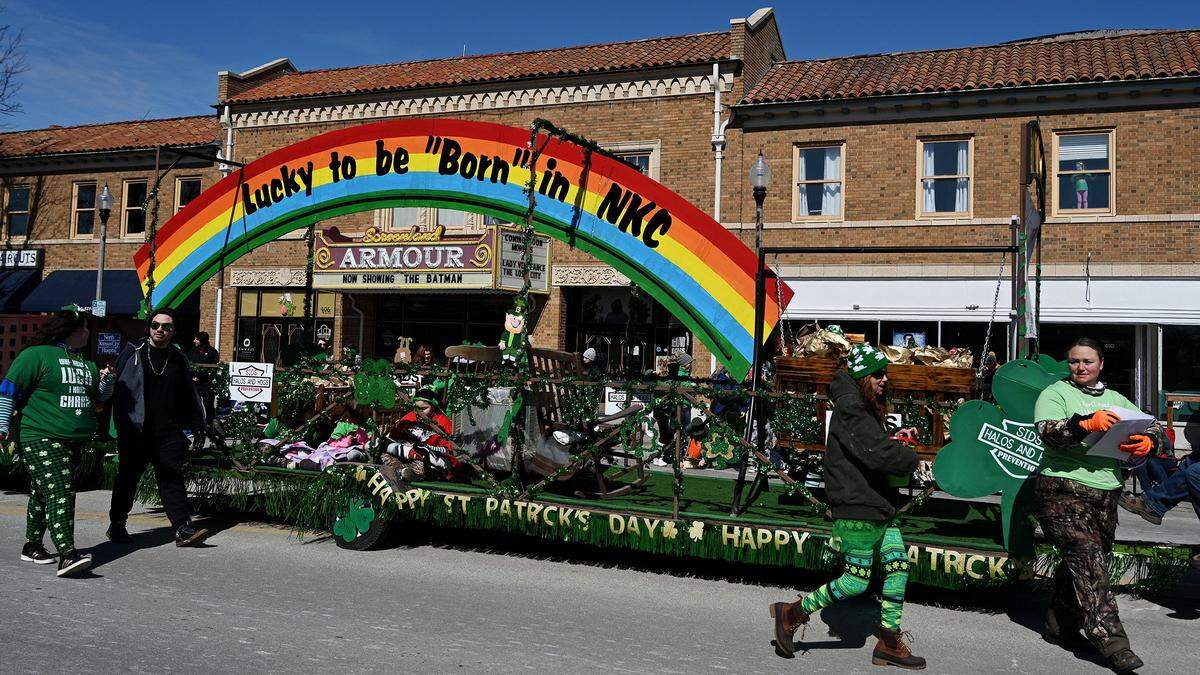 The float for Halos and Hogs, a SIDS awareness and prevention group, passes by the iconic Screenland Armour theater during the Snake Saturday Parade in North Kansas City on March 12.