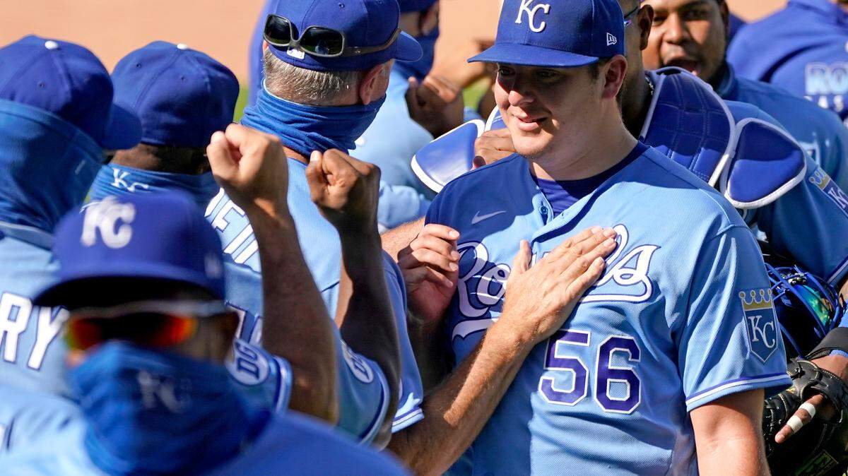 Kansas City Royals starting pitcher Brad Keller (56) celebrates with teammates after their baseball game against the Pittsburgh Pirates Sunday, Sept. 13, 2020, in Kansas City, Mo. Keller pitched a complete game and shut out the Pirates. (AP Photo/Charlie Riedel)