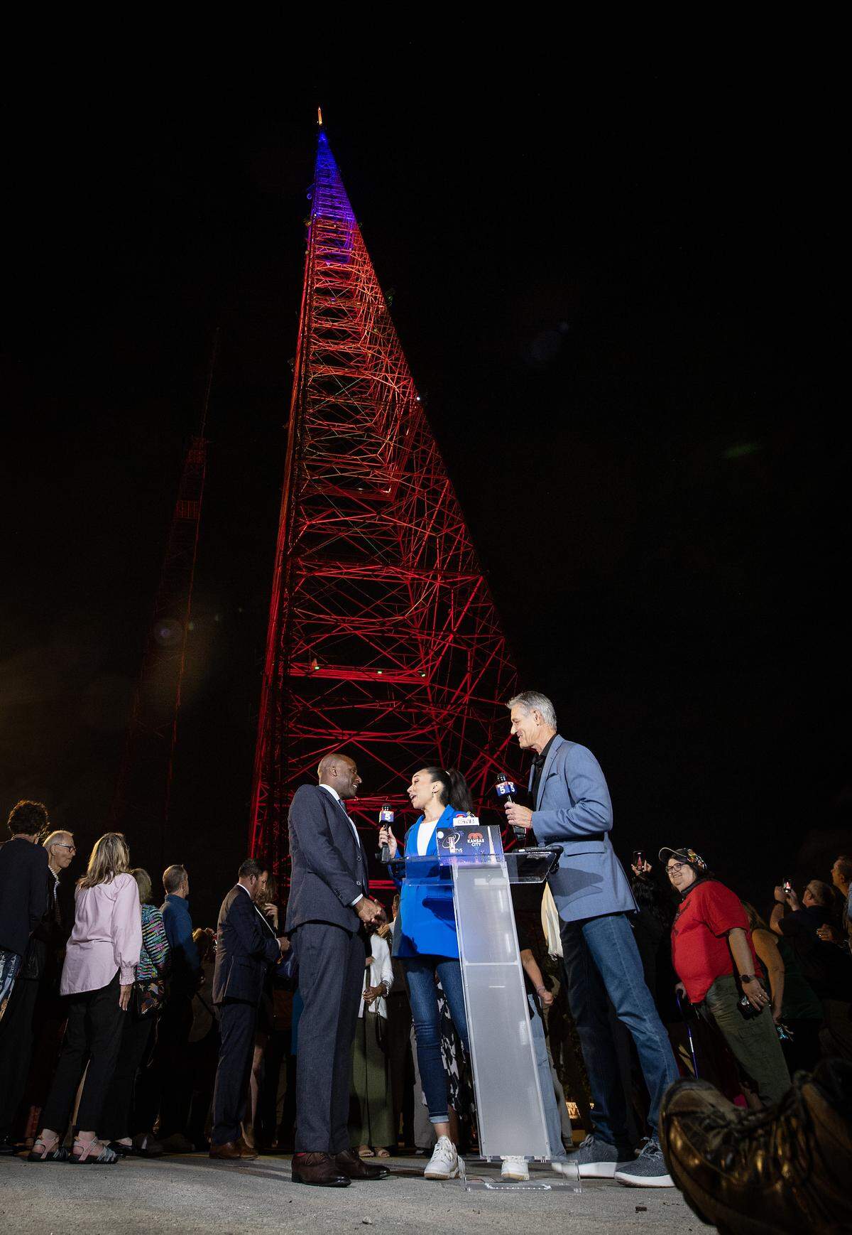 The KCTV Tower shined in the night after it was lit with new LED lights on Thursday, Sept. 18, 2025. Kansas City mayor Quinton Lucas, left, and KCTV anchors Lauren Magarino and Brad Stephens talked about the tower after Lucas pushed the button to turn the lights on. The original lights on the 1,042-feet-tall tower were shut down in 2004 due to aging infrastructure and maintenance costs.