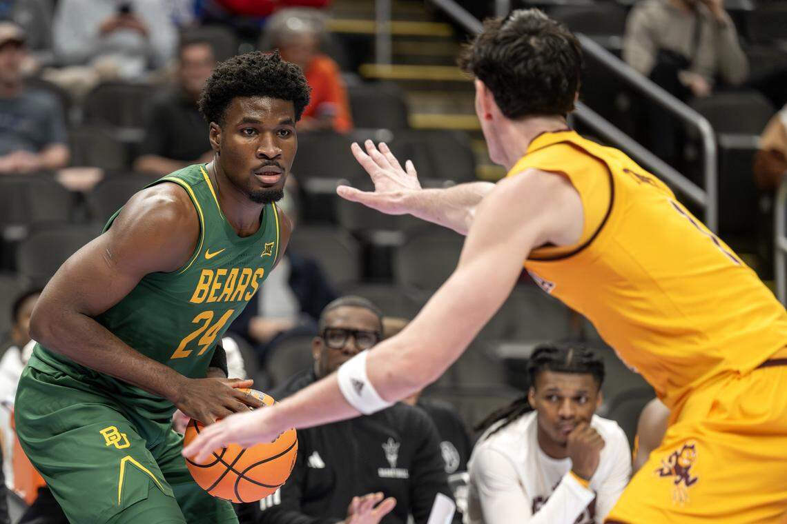 Baylor Bears guard Tounde Yessoufou (24) attempts to make a three point basket over Arizona State Sun Devils forward Andrija Grbovic (14) during the first half of the Big 12 Men's Basketball Tournament at T-Mobile Center on Tuesday, March 10, 2026, in Kansas City.