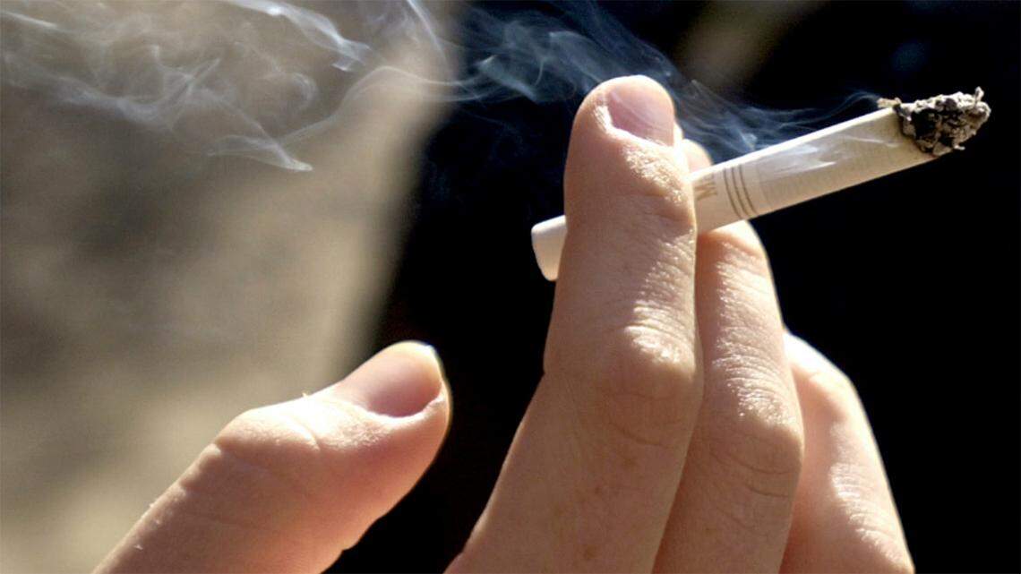 A person smokes a cigarette close-up
