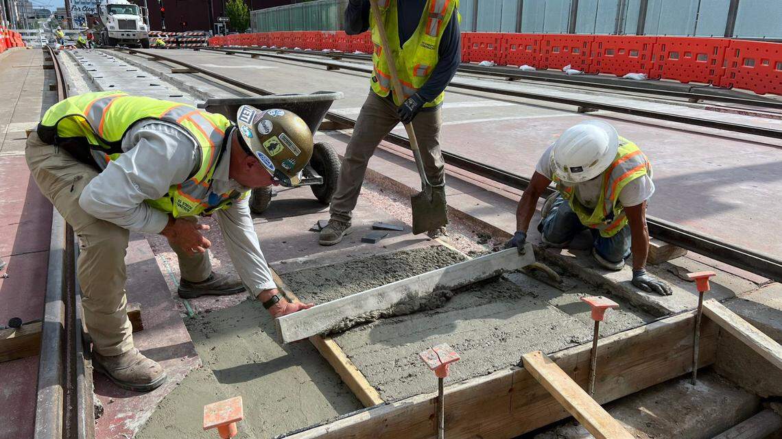 Crews smooth out concrete Wednesday evening as they make repairs to Kansas City Streetcar tracks after a rail buckled on the Main Street bridge over Interstate 670 on Independence Day, forcing the agency to abruptly suspend service. The work was being done in preparation for resetting the rails on Thursday.